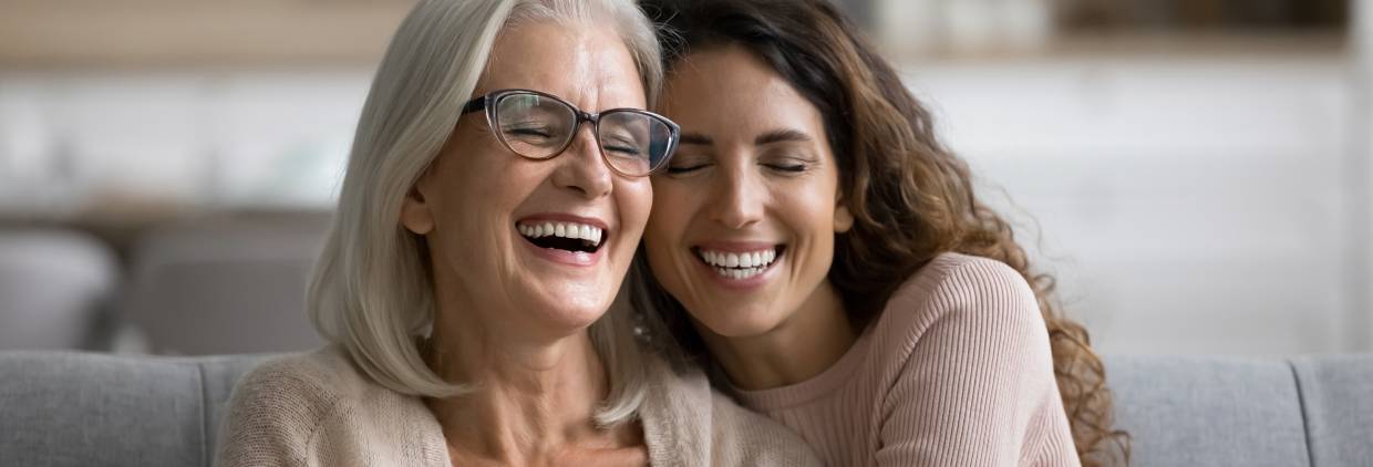 two women hugging and laughing