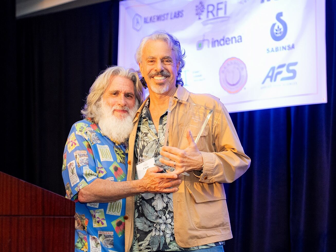 Chris Kilham (right) receives the 2025 ABC Champion Award from Mark Blumenthal, founder and executive director of ABC
