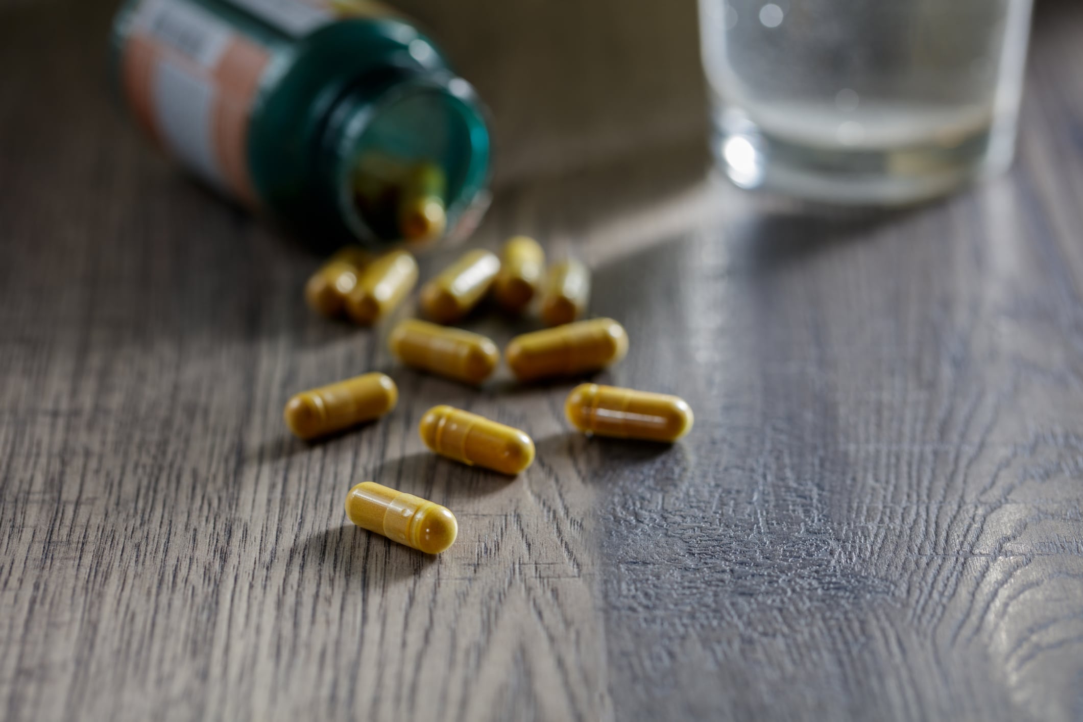 A close-up view of turmeric tablets on a wooden table